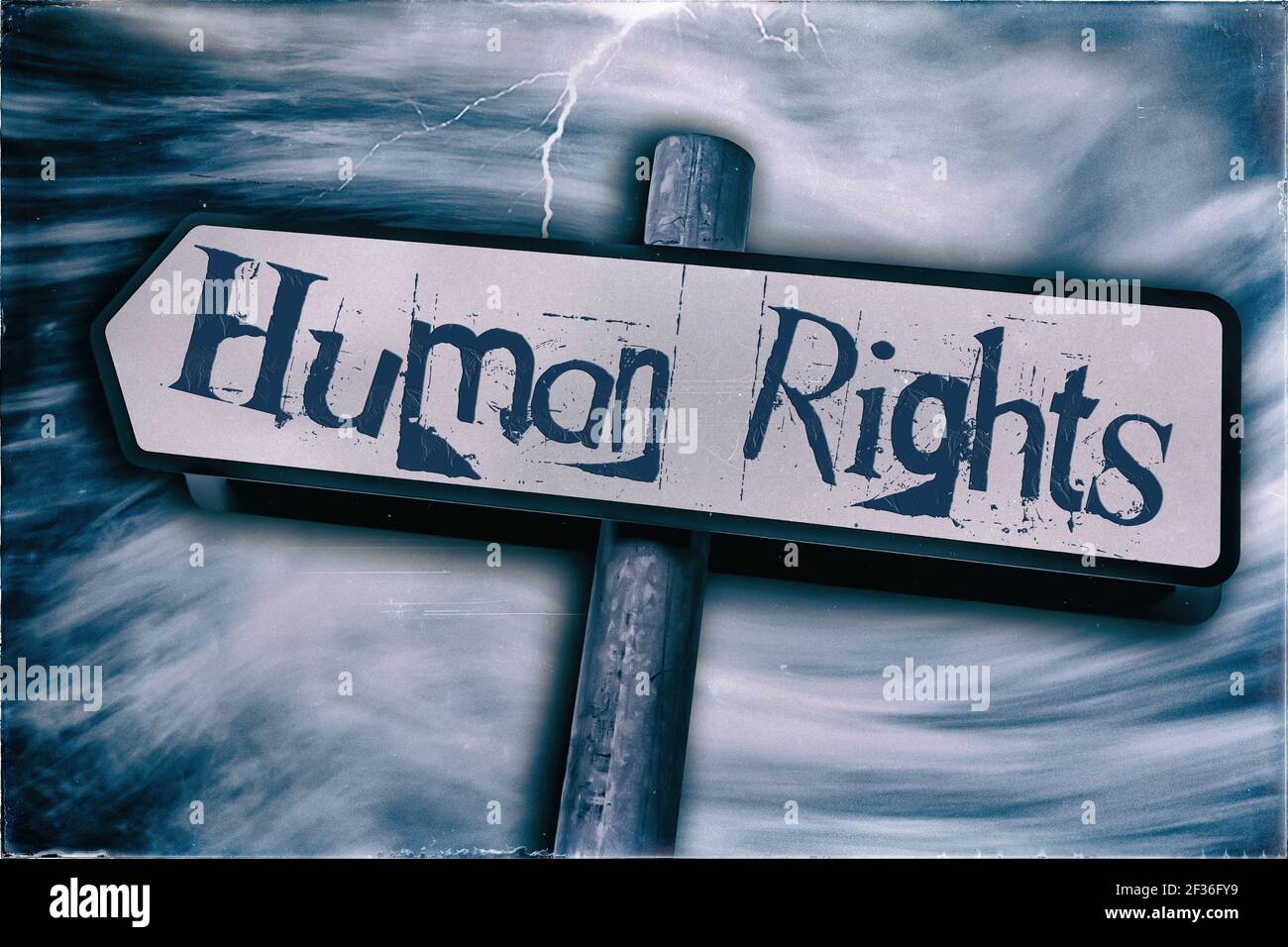 Human Rights displayed on a Sign post with a  Storm in the background Stock Photo