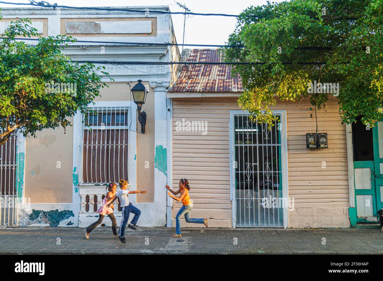 Santo Domingo Dominican Republic,Ciudad Colonia Zona Colonial,Calle Portes residential street neighborhood house home,Hispanic girls playing youngster Stock Photo