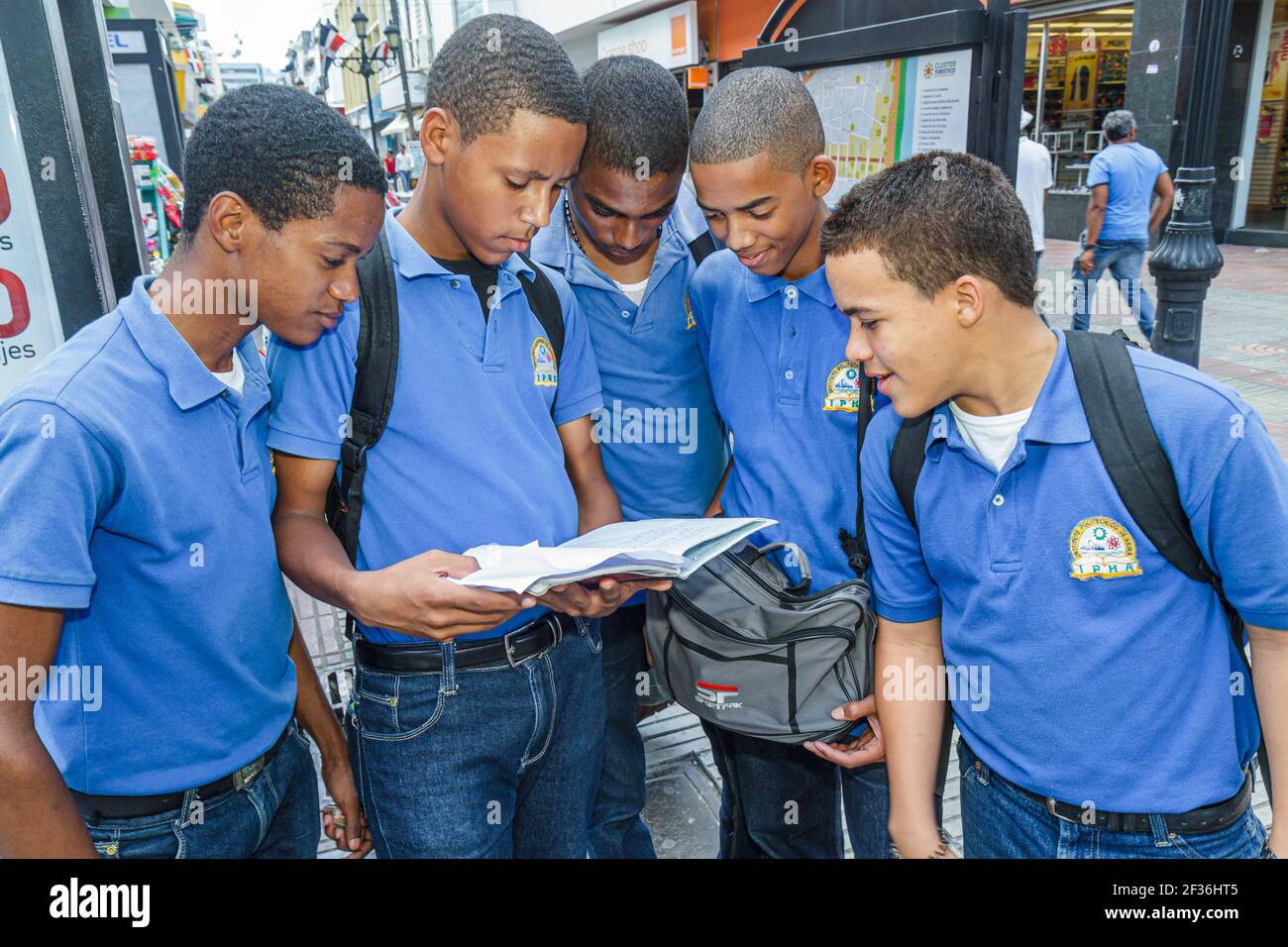 Santo Domingo Dominican Republic,Ciudad Colonial Calle el Conde Peatonal,Black Hispanic students boys teens teenagers reading book,wearing school unif Stock Photo