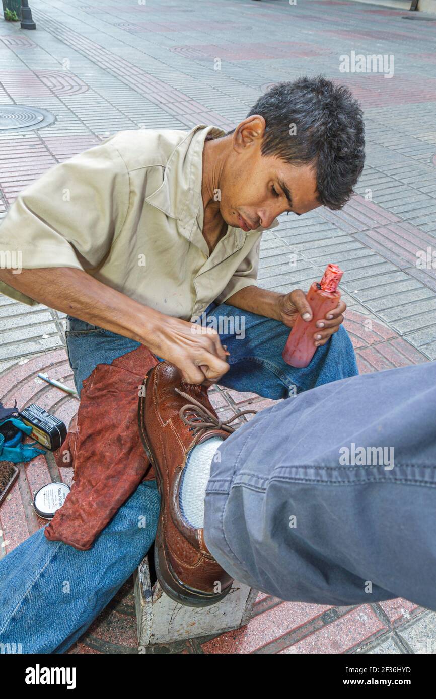 Santo Domingo Dominican Republic,Ciudad Colonia Zona Colonial,Calle el Conde Peatonal pedestrian mall,Hispanic man street shoeshine boy boot polisher Stock Photo