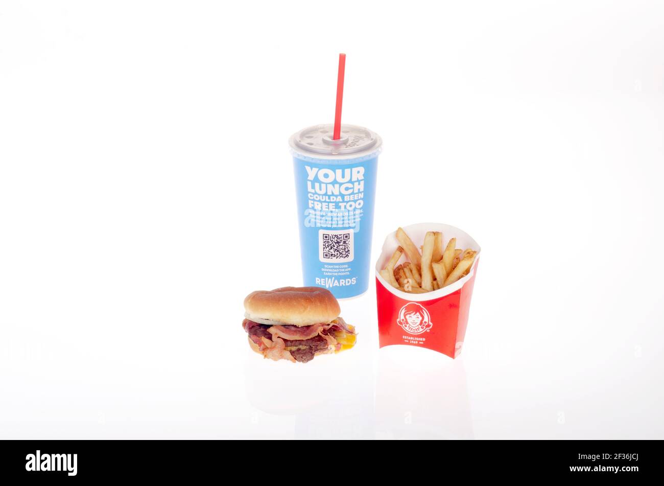 Wendy's Bacon Double Stack Cheeseburger in a Bun consisting of 2 Patties, Bacon & Cheese with French Fries aka Chips and a Soda Drink Stock Photo