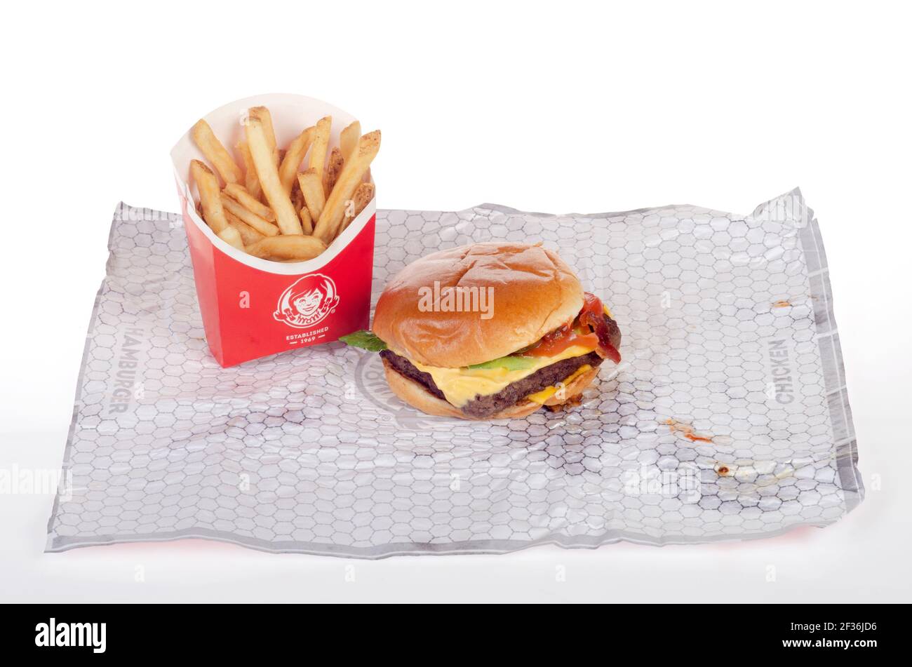 Wendy's Dave's Single Classic Cheeseburger with French Fries aka Chips on Wrapper Stock Photo