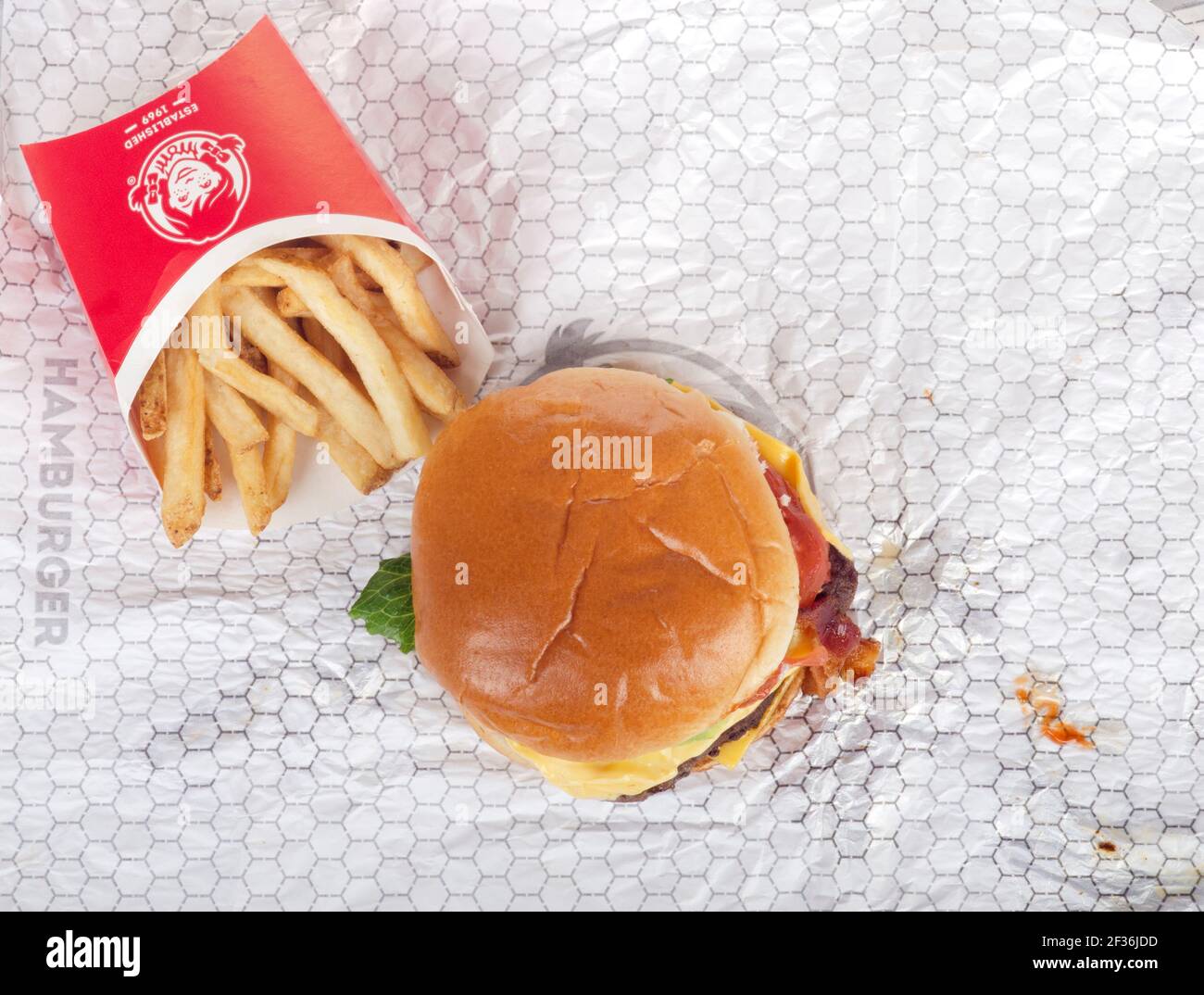 Wendy's Dave's Single Classic Cheeseburger with French Fries or Chips on Wrapper Stock Photo