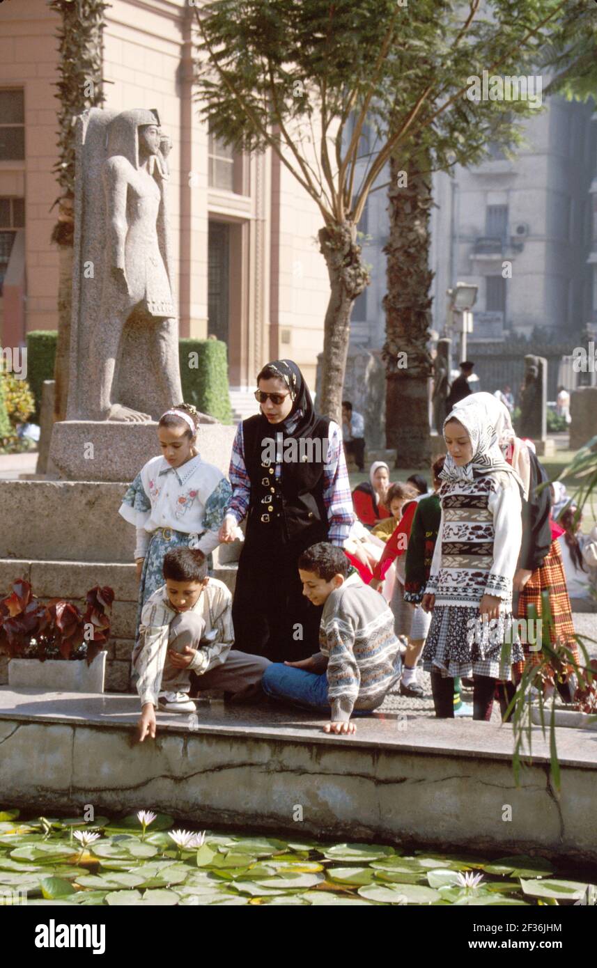 Cairo Egypt Egyptian Muslim Egyptian Museum,teen teenage teenagers girls boys teacher Muslim students heads covered hijab,school class field trip, Stock Photo