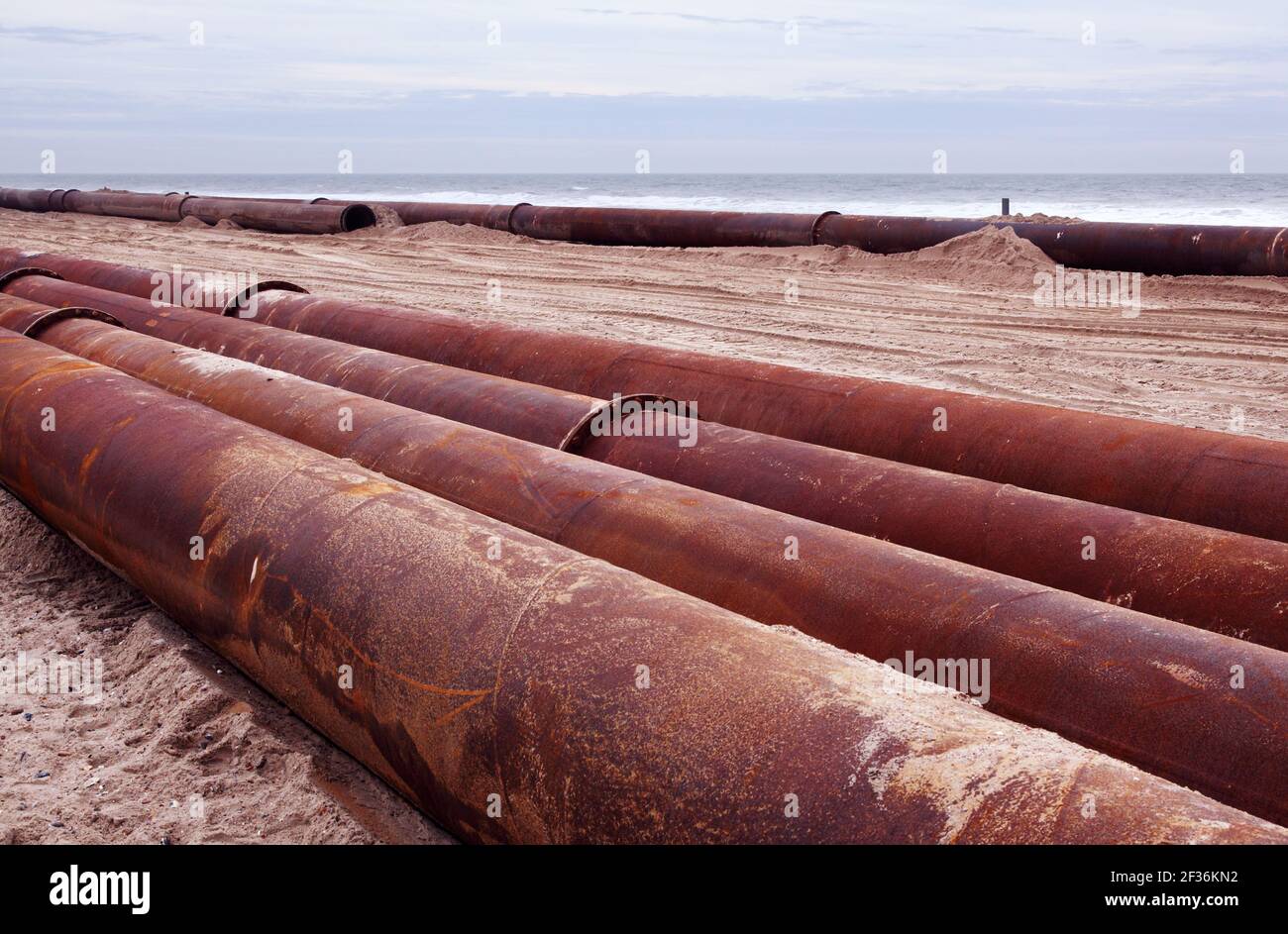 Large metal pipes or pipeline on Boscombe beach, Bournemouth. Used to  pump more sand onto beaches from offshore. Stock Photo