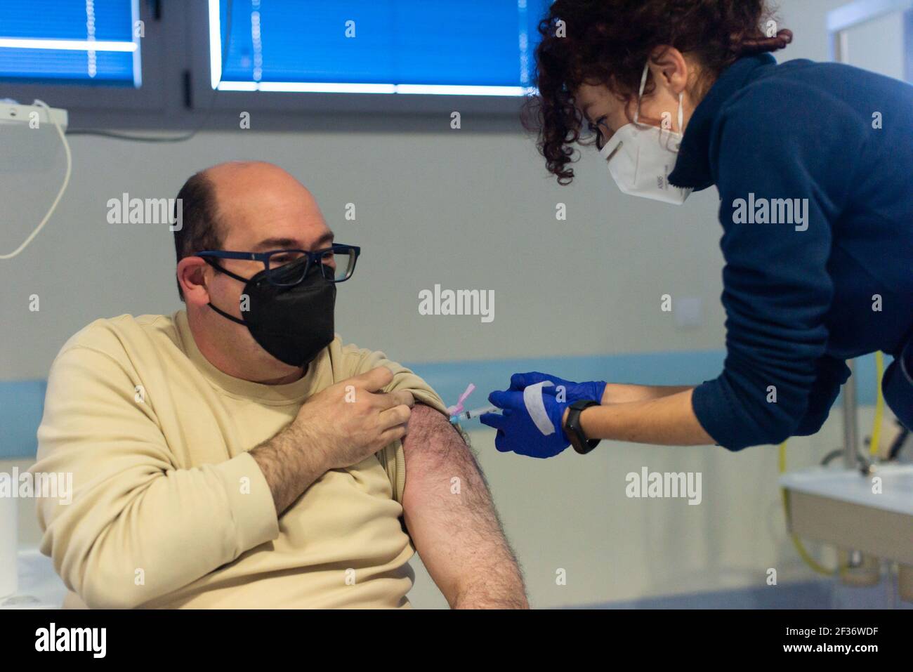 A healthcare worker administers Astra Zeneca COVID19 Vaccine to a frontline workers at Coria City Hospital. Some European countries have cancelled the administration of AstraZeneca vaccine due the appearance of some side effects in people who had received it recently. Stock Photo