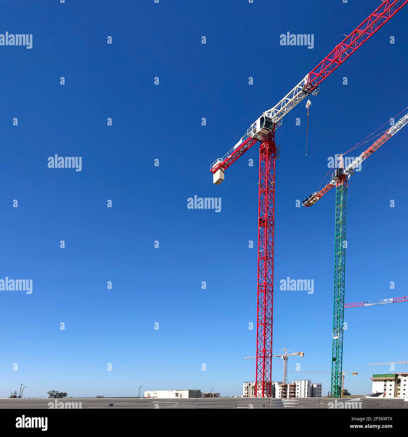 Constraction cranes on the blu sky background. Stock Photo