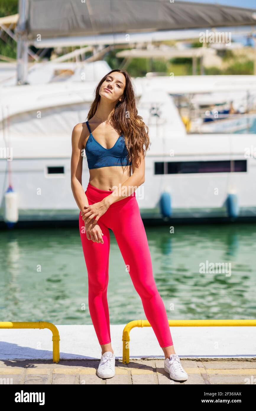 https://c8.alamy.com/comp/2F36XAX/fitness-model-in-red-sportswear-outfit-posing-on-waterfront-harbour-2F36XAX.jpg