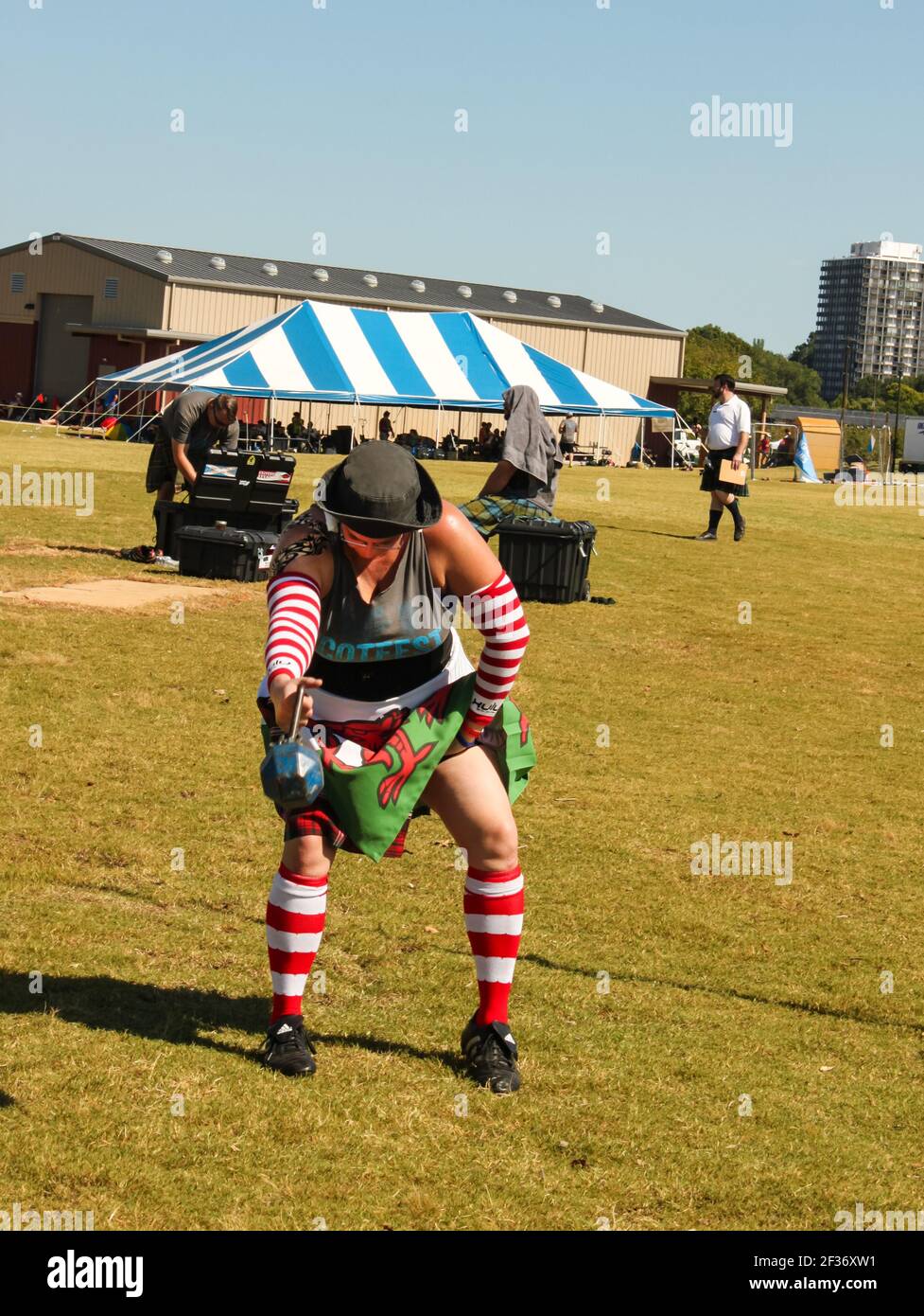 Tulsa Oklahoma USA circa 9 - 2016 Woman competing in Weight of height strength test at Scottish Highland games getting ready to throw weight over high Stock Photo