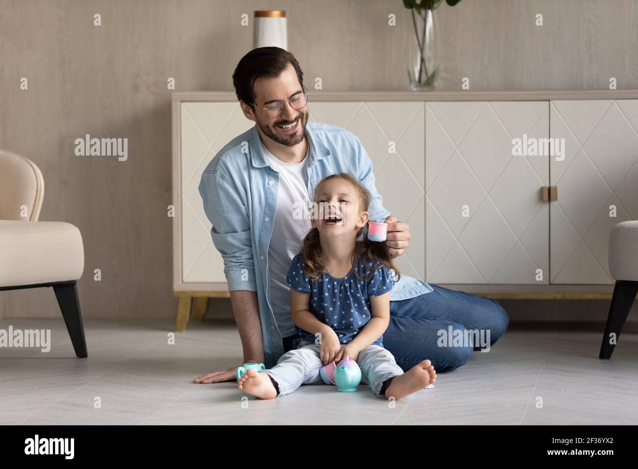 Caring young dad play at home with daughter Stock Photo - Alamy