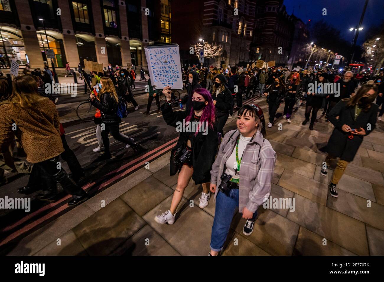 London, UK. 15th Mar, 2021. Marching back past people watching inside Portcullis House - The protest leaves Parliament Square and heads on to Westminster bridge and then to New Scotland Yard. Protests in central London after the police cleared the vigil at the Clapham Common Bandstand for Sarah Everard. They coincide with the debate in Parlaiment on a new bill which many believe will heavily restrict protests but do little for female victims of crime. Credit: Guy Bell/Alamy Live News Stock Photo