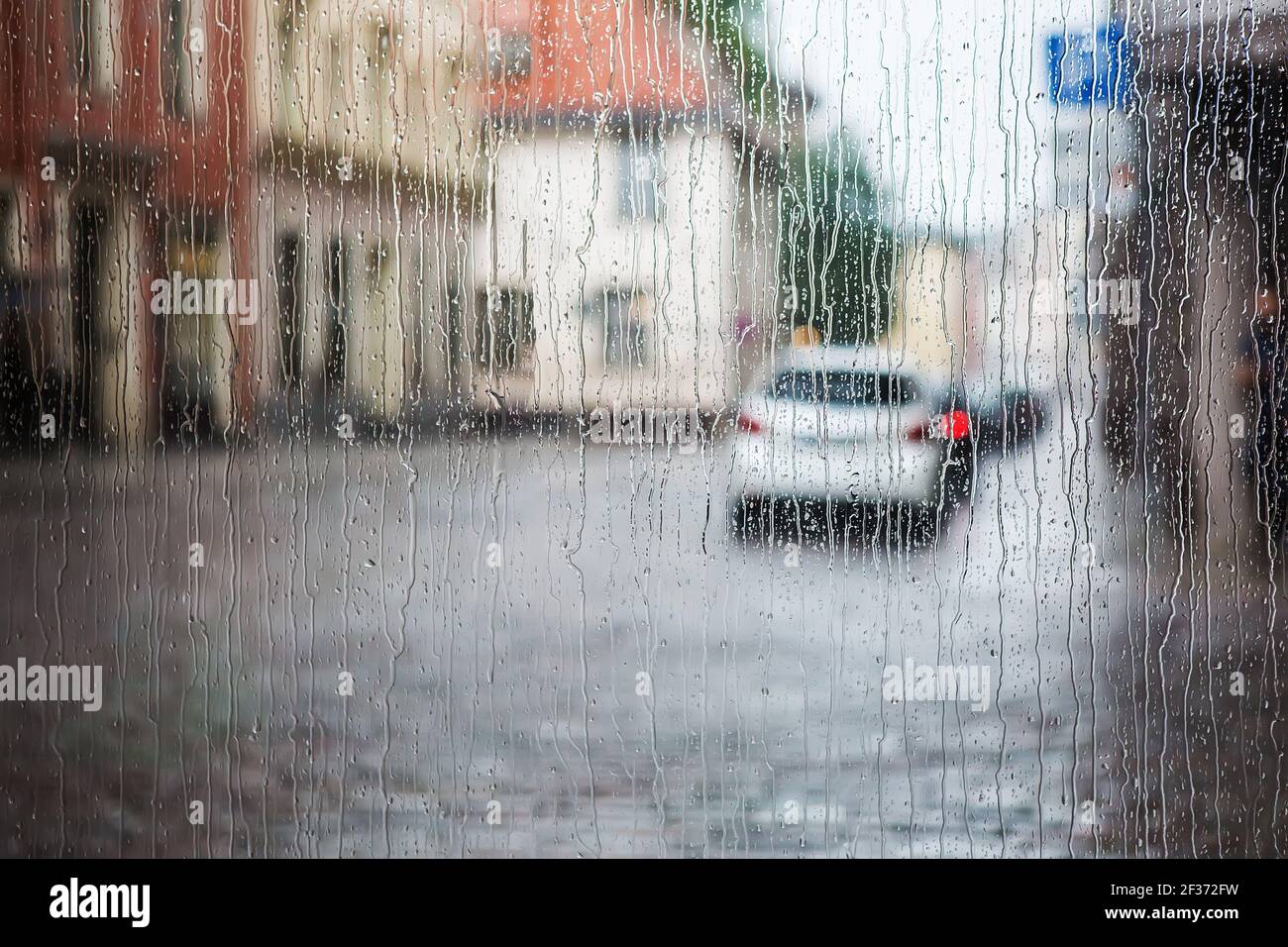 rain in the historic old center of the European city. The view through the glass Stock Photo