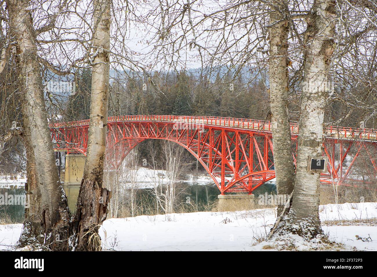 The red bridge spanning over the river during winter time in Ione