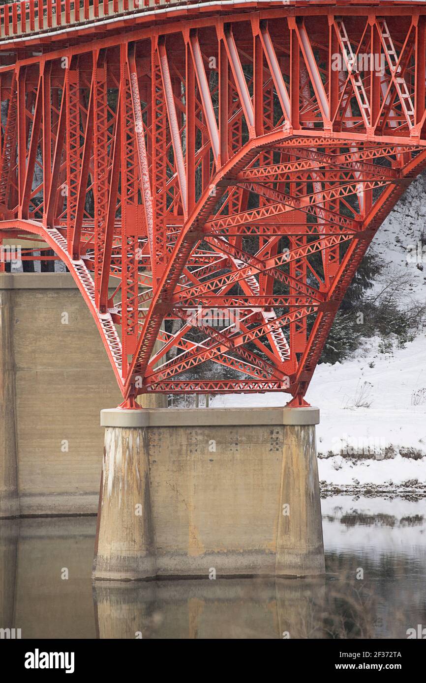A close up of the support structure of a red bridge in Ione, Washington