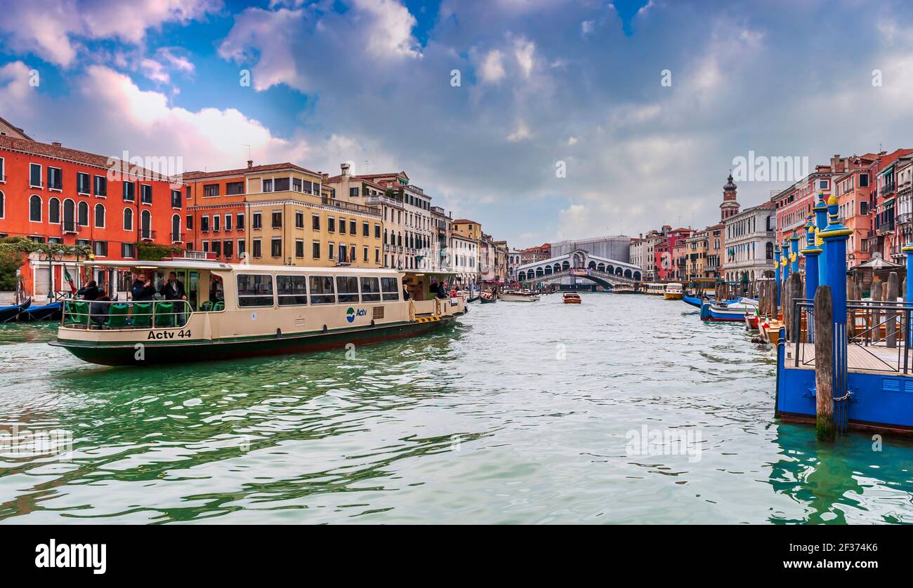 Vaporetto on the Grand Canal and the typical facades and at the far end the Rialto Bridge in Venice in Veneto, Italy Stock Photo