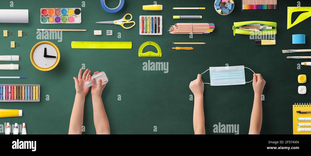 Flat lay top view of face mask and school supplies, back to school and ...