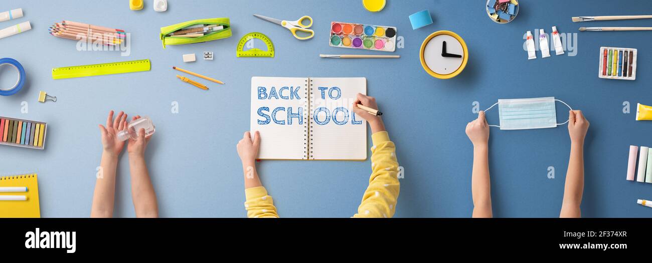 Flat lay top view of face mask and school supplies, back to school and ...