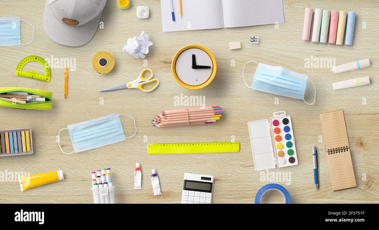 Flat lay top view of face mask and school supplies, back to school and ...