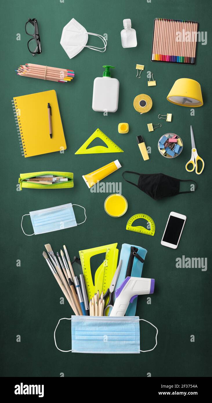 Flat lay top view of face mask and school supplies, back to school and ...