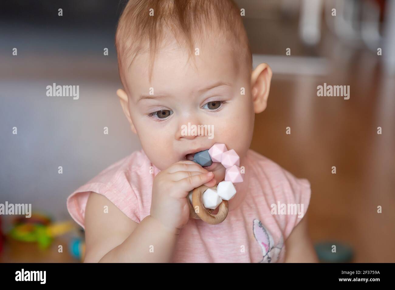 Little baby girl with teething toy Stock Photo