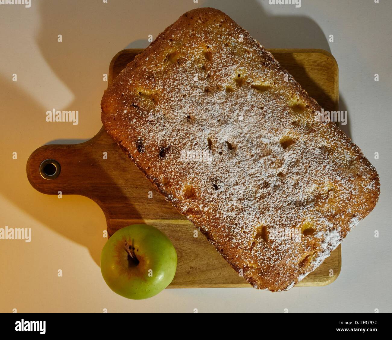 Apple Plum Cake decorated with an apple on a cutting table Stock Photo