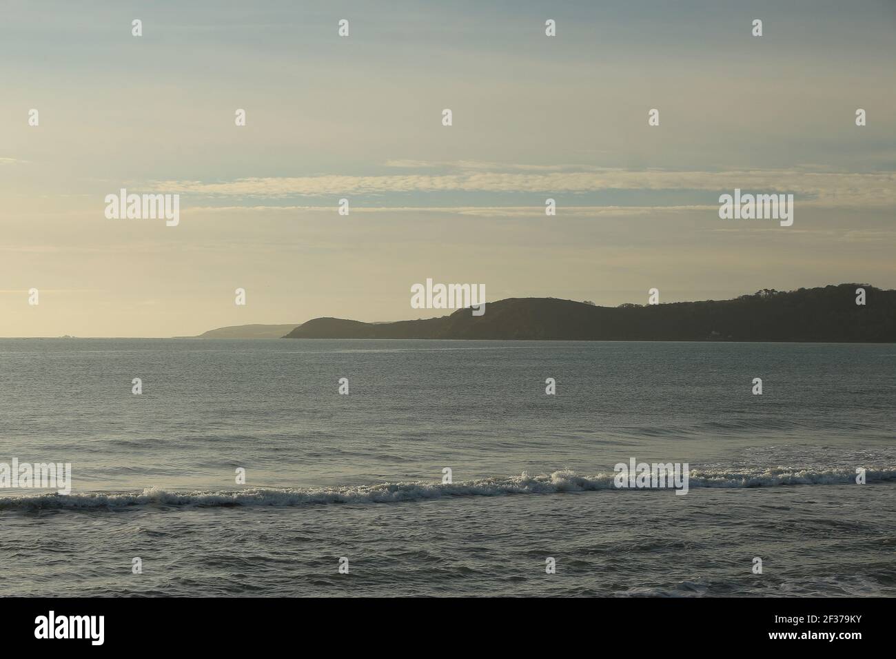 A panoramic shot across the atlantic to a peninsula in the distance off the southern coast of England in the county of Cornwall, outside the town of S Stock Photo