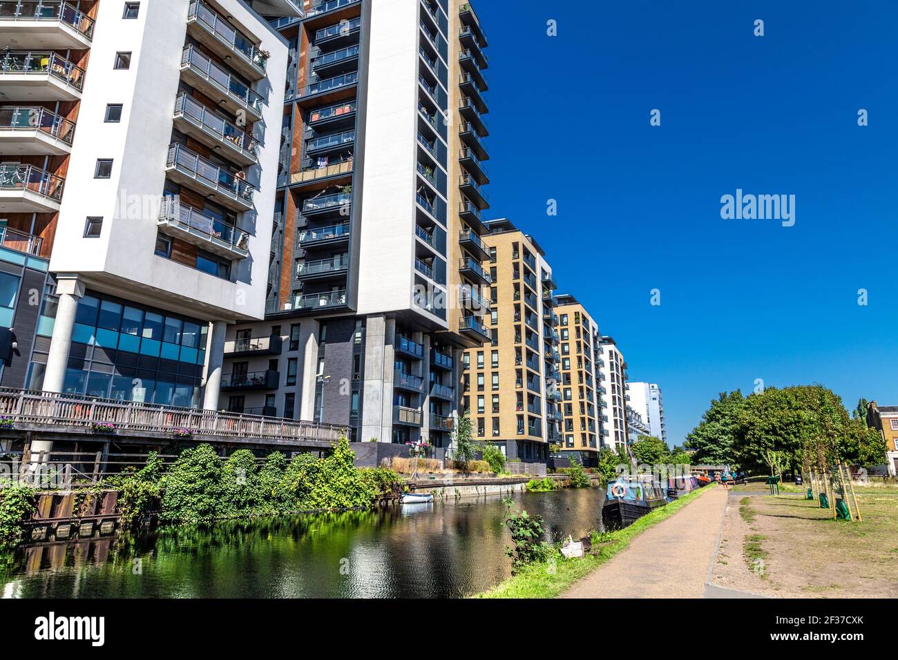 New-build residentail tower clocks along the Regent's Canal in Mile End, London, UK Stock Photo