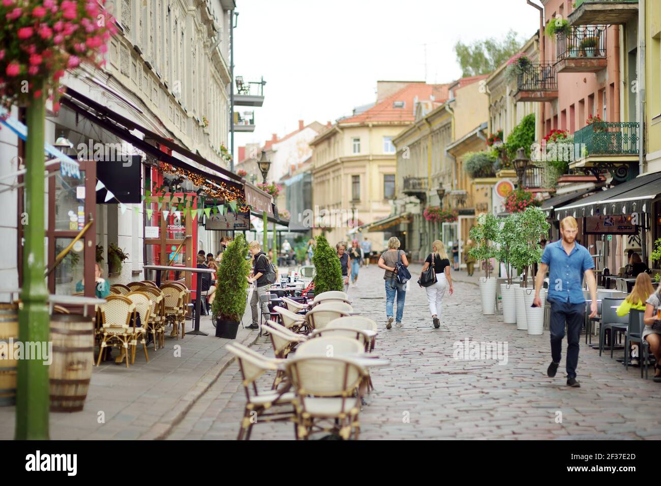 KAUNAS, LITHUANIA - AUGUST 16, 2020: Townspeople and tourists strolling on the Vilnius street (Vilniaus gatve) in medieval Kaunas old town. Stock Photo
