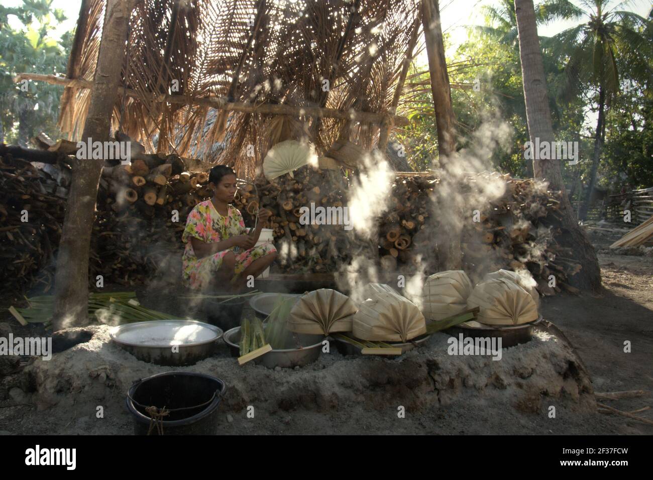 A woman boiling palm sap to make palm sugar in Oehandi village, Rote