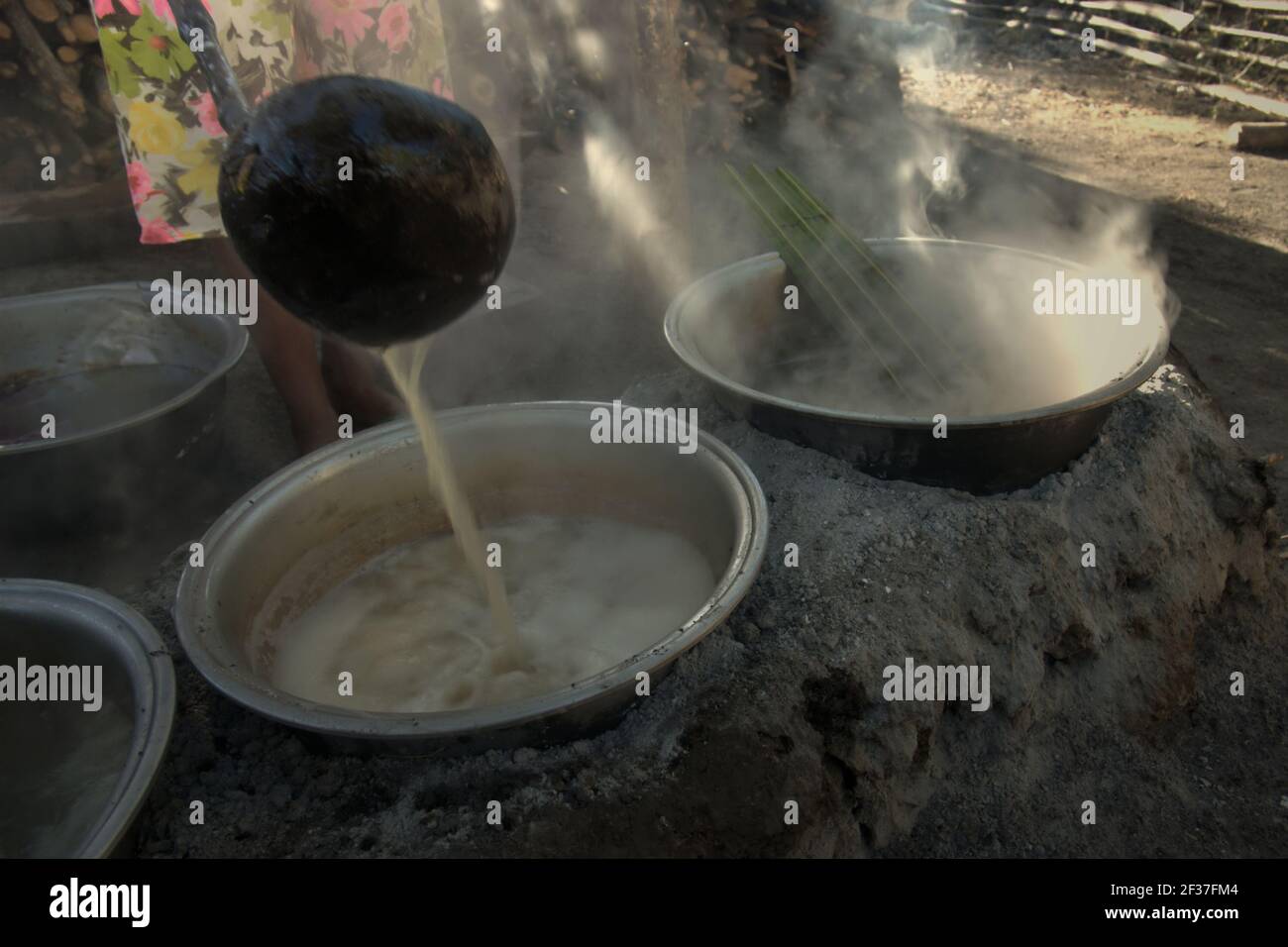Boiling palm sap to make palm sugar, an alternative source of income for villagers living in Rote Island, Indonesia. Stock Photo