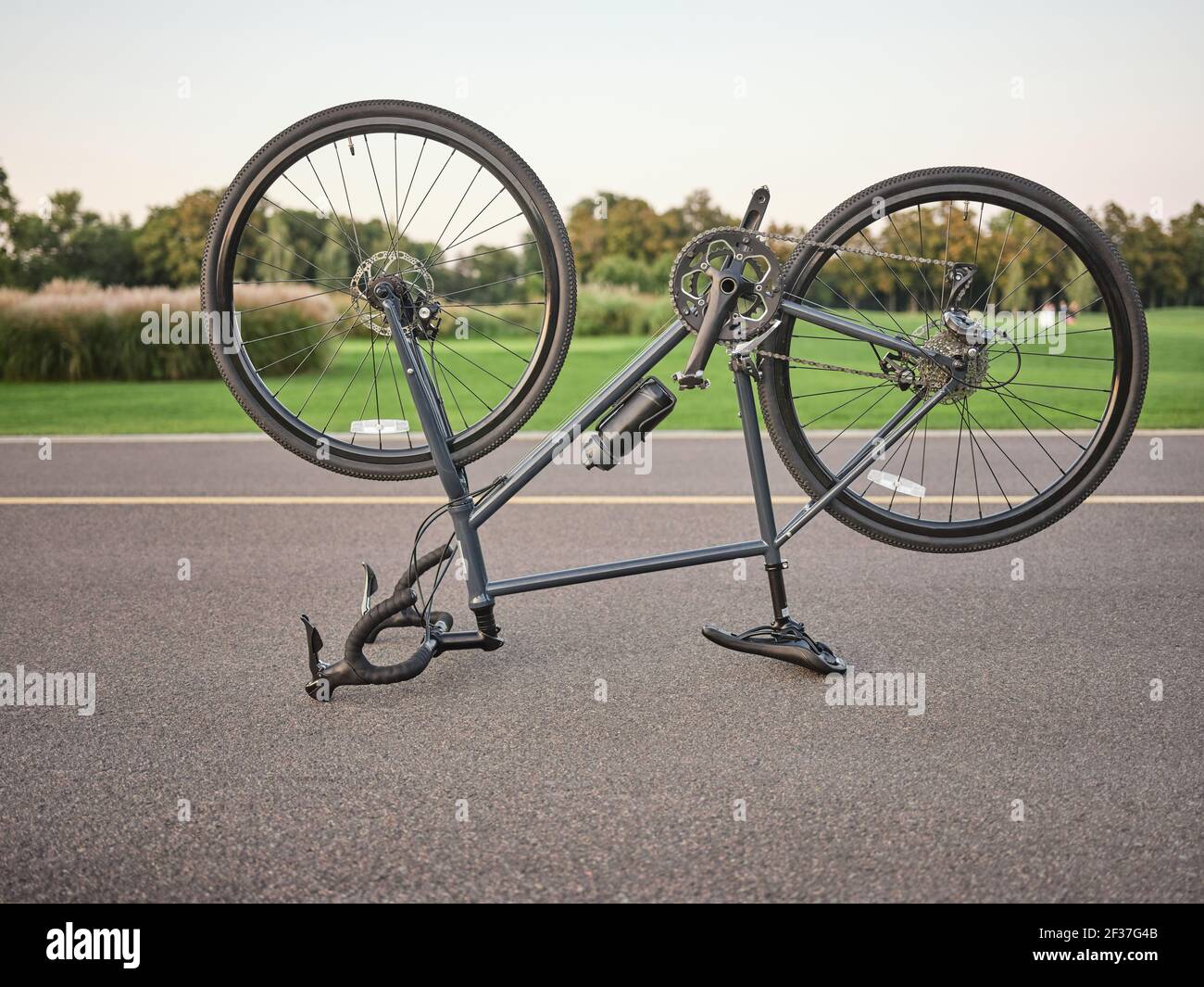 Broken bike. Malfunctioning upside down road bicycle parked for