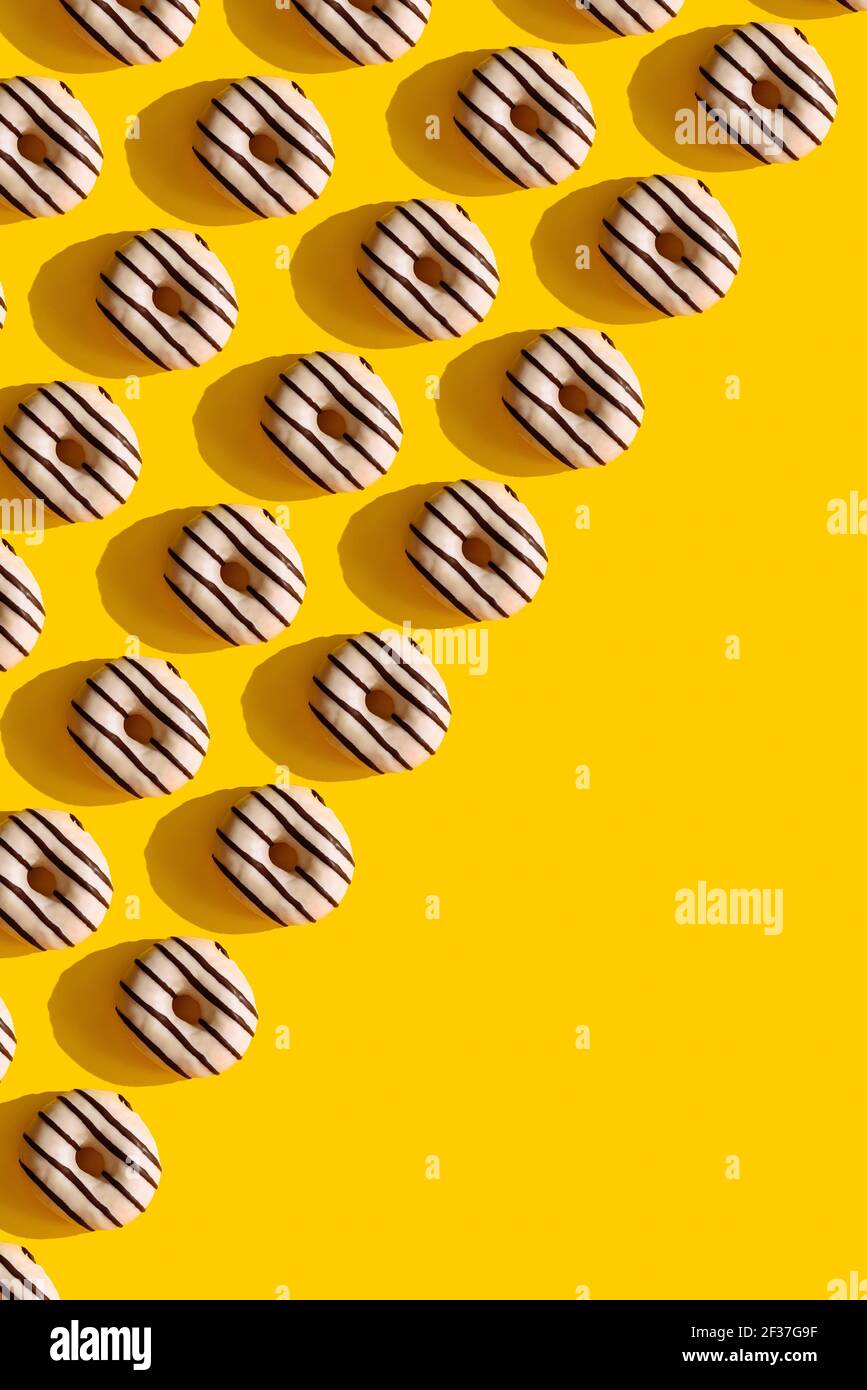 a pattern on a yellow background of donuts Stock Photo