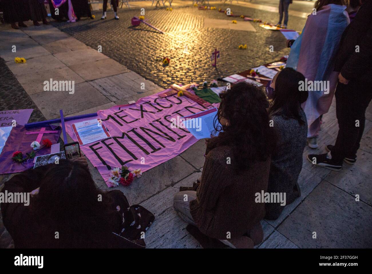 Barcelona, Spain. 15th Mar, 2021. Women are seen singing in front of a placard that says, Mexico femicide during the demonstration.The collective of Mexican women in Barcelona, Mexican Fury (Furia Mexicana) have convened in front of the town hall as they protest against feminicide and sexist violence in Mexico and paid tribute to various victims of feminicide in Mexico in the last year. (Photo by Thiago Prudencio/SOPA Images/Sipa USA) Credit: Sipa USA/Alamy Live News Stock Photo