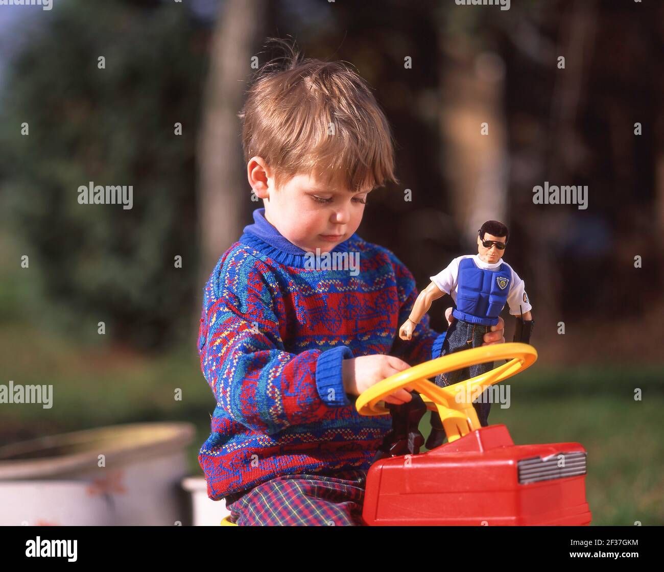 Toddler playing with Action Man toy, Winkfield, Berkshire, England, United Kingdom Stock Photo