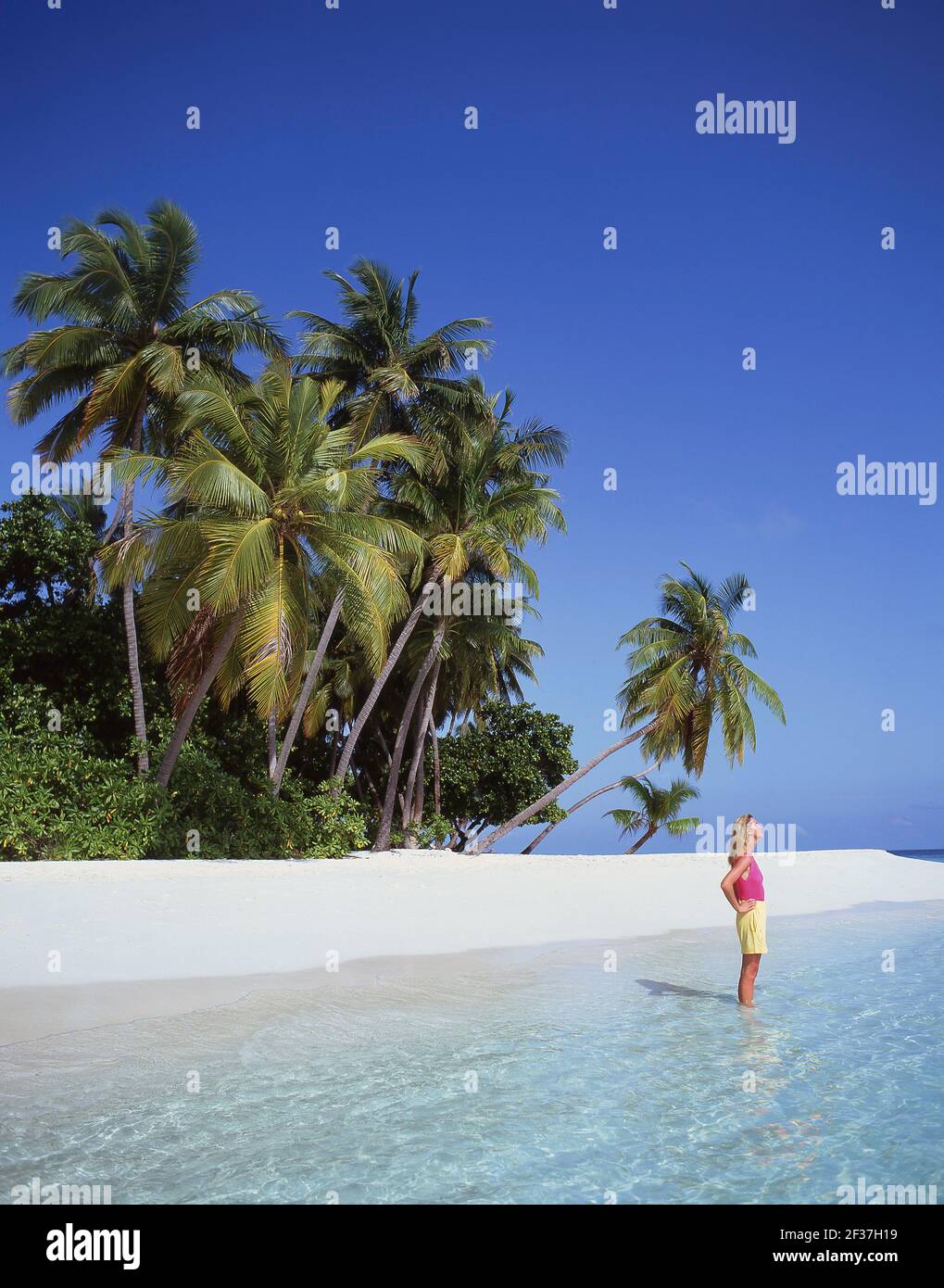 Young woman on tropical beach, Kuda Bandos Island, Kaafu Atoll, Republic of Maldives Stock Photo