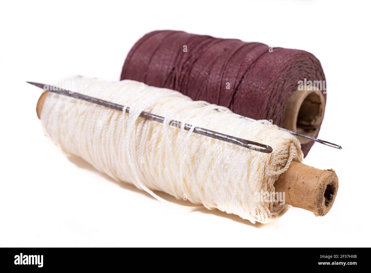 Strong twine and old heavy tailoring needles. Accessories used in a  leathercraft workshop. Light background Stock Photo - Alamy