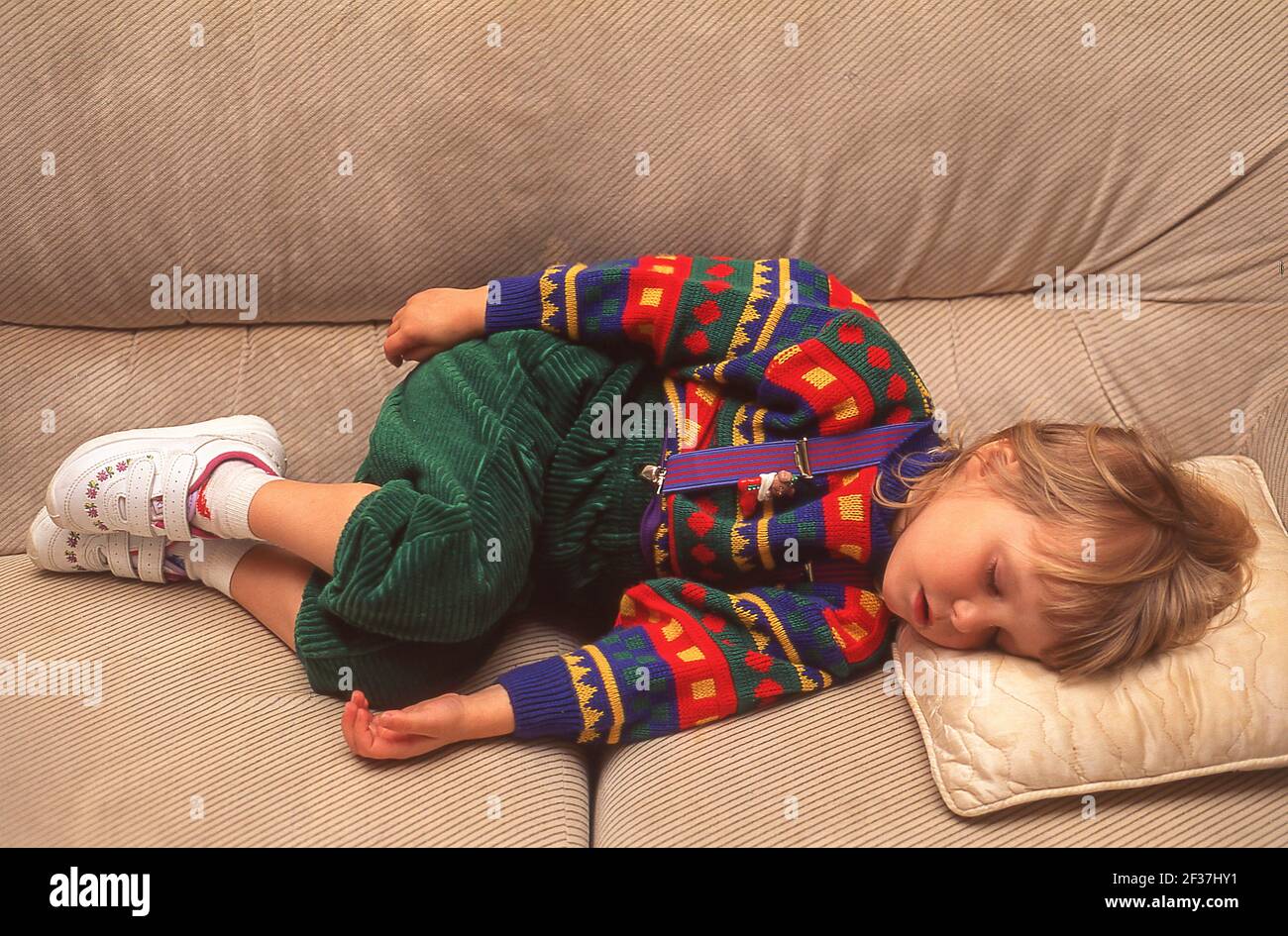 Young girl asleep on a couch, Winkfield, Berkshire, England, United Kingdom Stock Photo