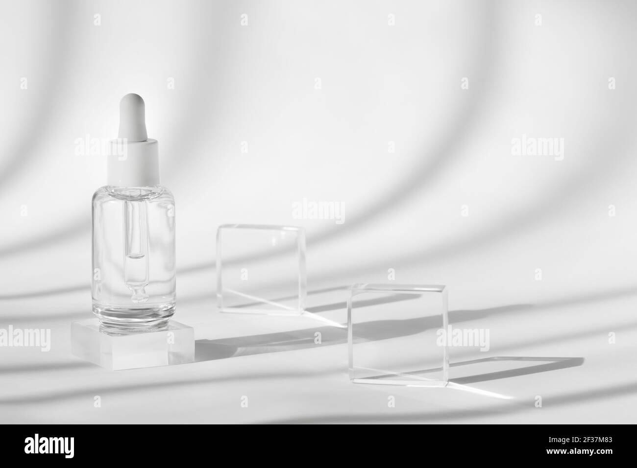 Download Serum Cosmetic Bottle Mockup On Acrylic Transparent Solid Block Pedestal On White Background Shadow From Sun Natural Light From Windows Geometric Stock Photo Alamy