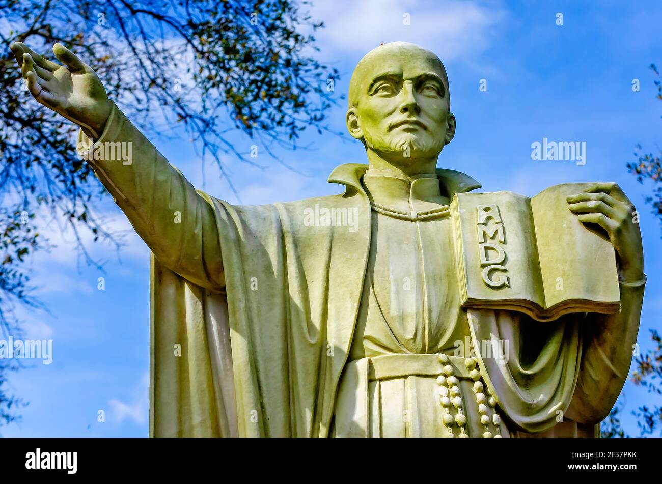 A statue of St. Ignatius of Loyola stands in a small parish cemetery at Spring Hill College, March 14, 2021, in Mobile, Alabama. Stock Photo