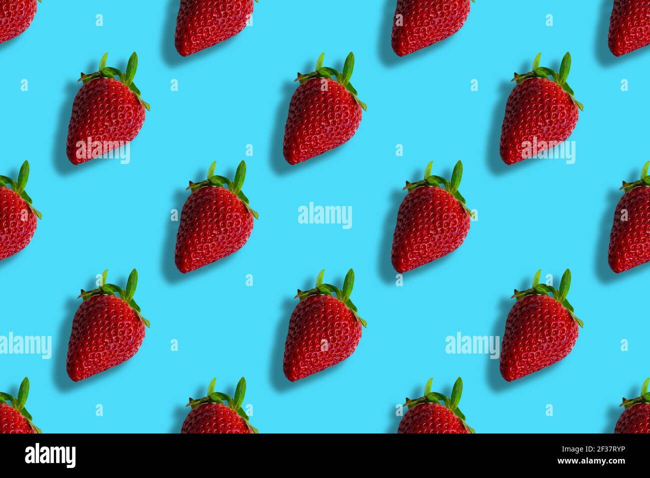 Pattern of strawberries isolated on blue background. Seamless pattern Stock Photo