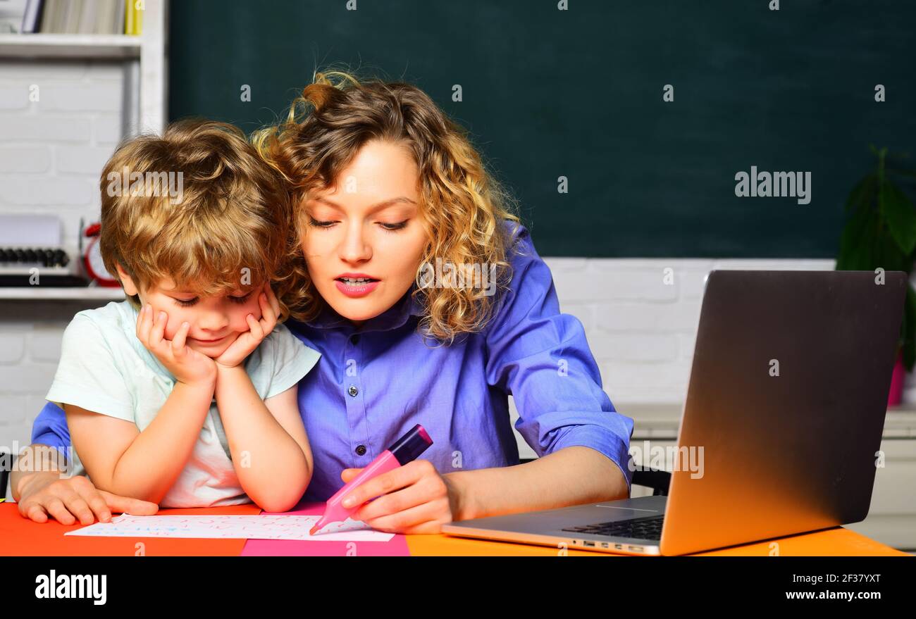 Elementary school. Education. First day at school. Little child learning with mother. Homework. Stock Photo