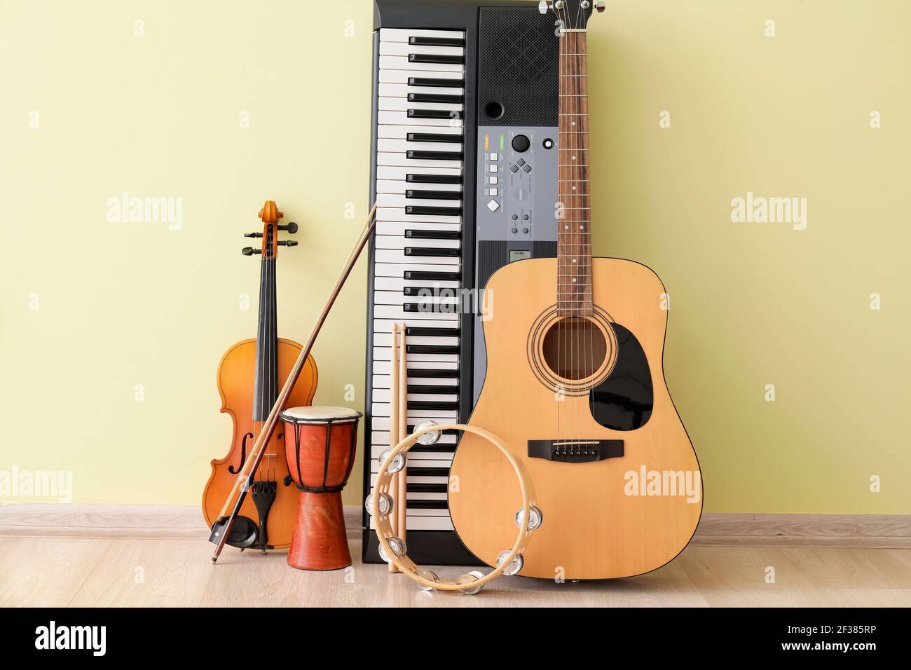 Different musical instruments near color wall Stock Photo - Alamy