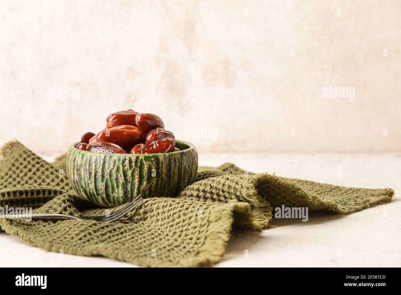 Bowl with sweet dried dates on table Stock Photo - Alamy