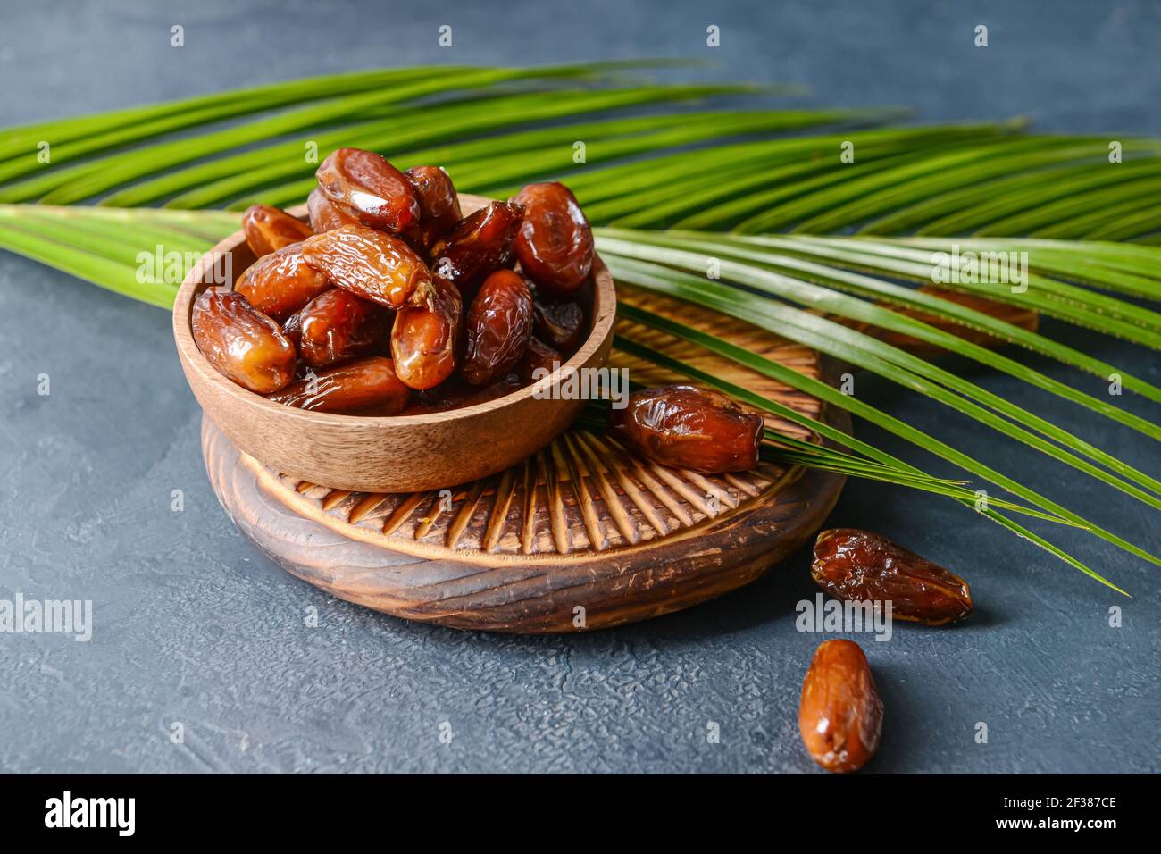 Bowl with sweet dried dates on dark background Stock Photo - Alamy