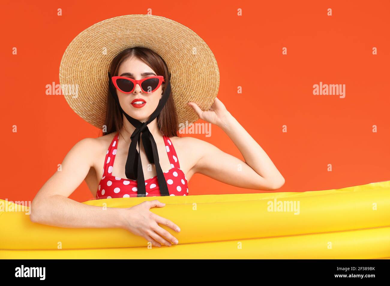 Beautiful young woman with inflatable mattress on color background Stock Photo
