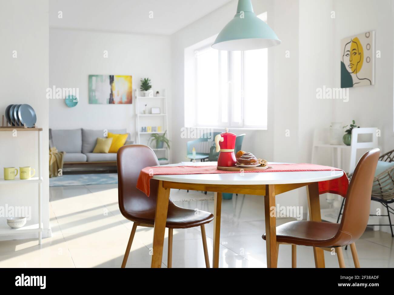 Dining table in interior of living room Stock Photo - Alamy