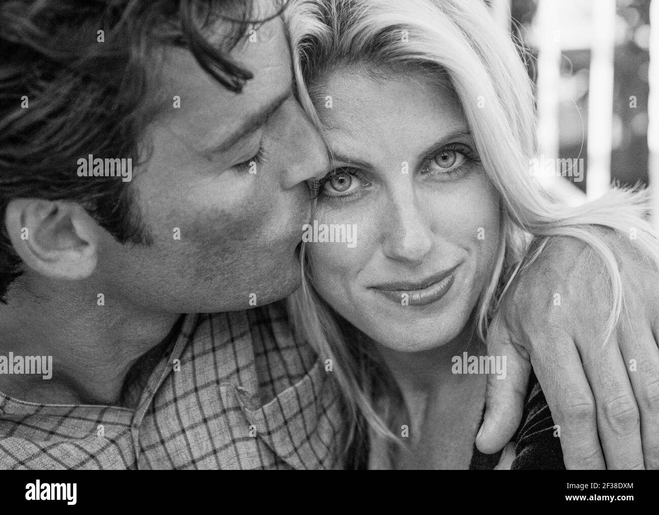 A Man kissing woman on the cheek. Stock Photo