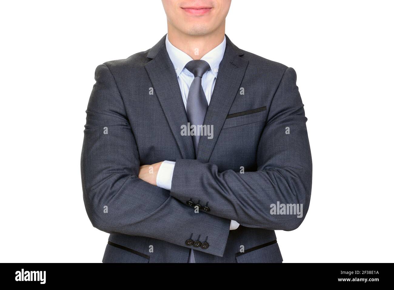 Businessman in dark gray suit folding his arms - isolated on white background Stock Photo