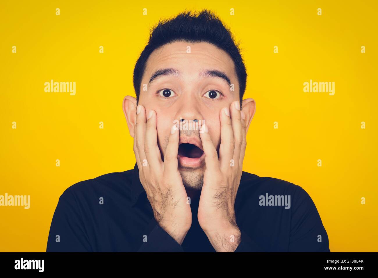 A man expressing shocked and scared face, feeling and emotion concept - vintage tone effect Stock Photo