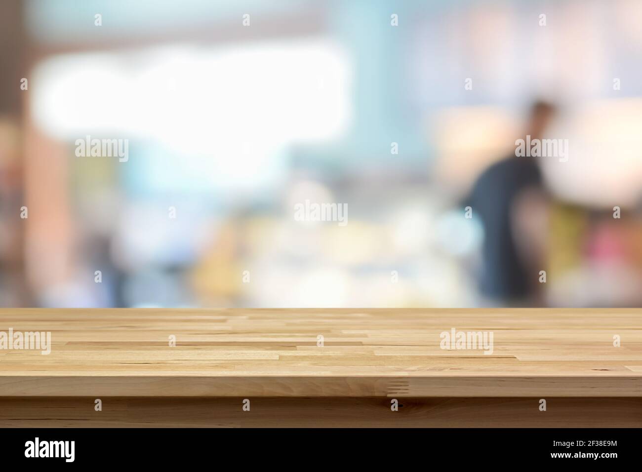 Wood table top on blur background of coffee shop interior - can be used for display or montage your products Stock Photo